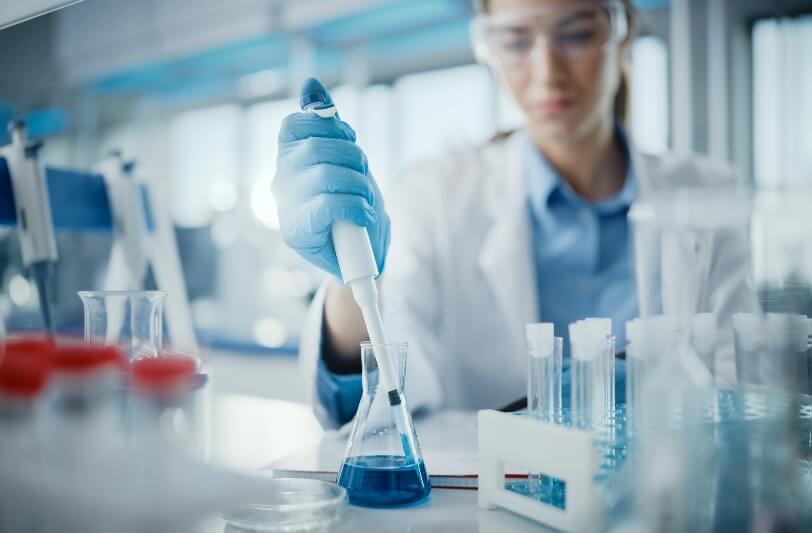 Scientist putting liquid in a container